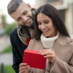 Happy young woman receiving a love letter