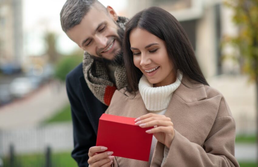 Happy young woman receiving a love letter