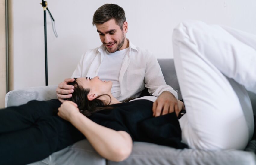 Optimistic couple on sofa chatting