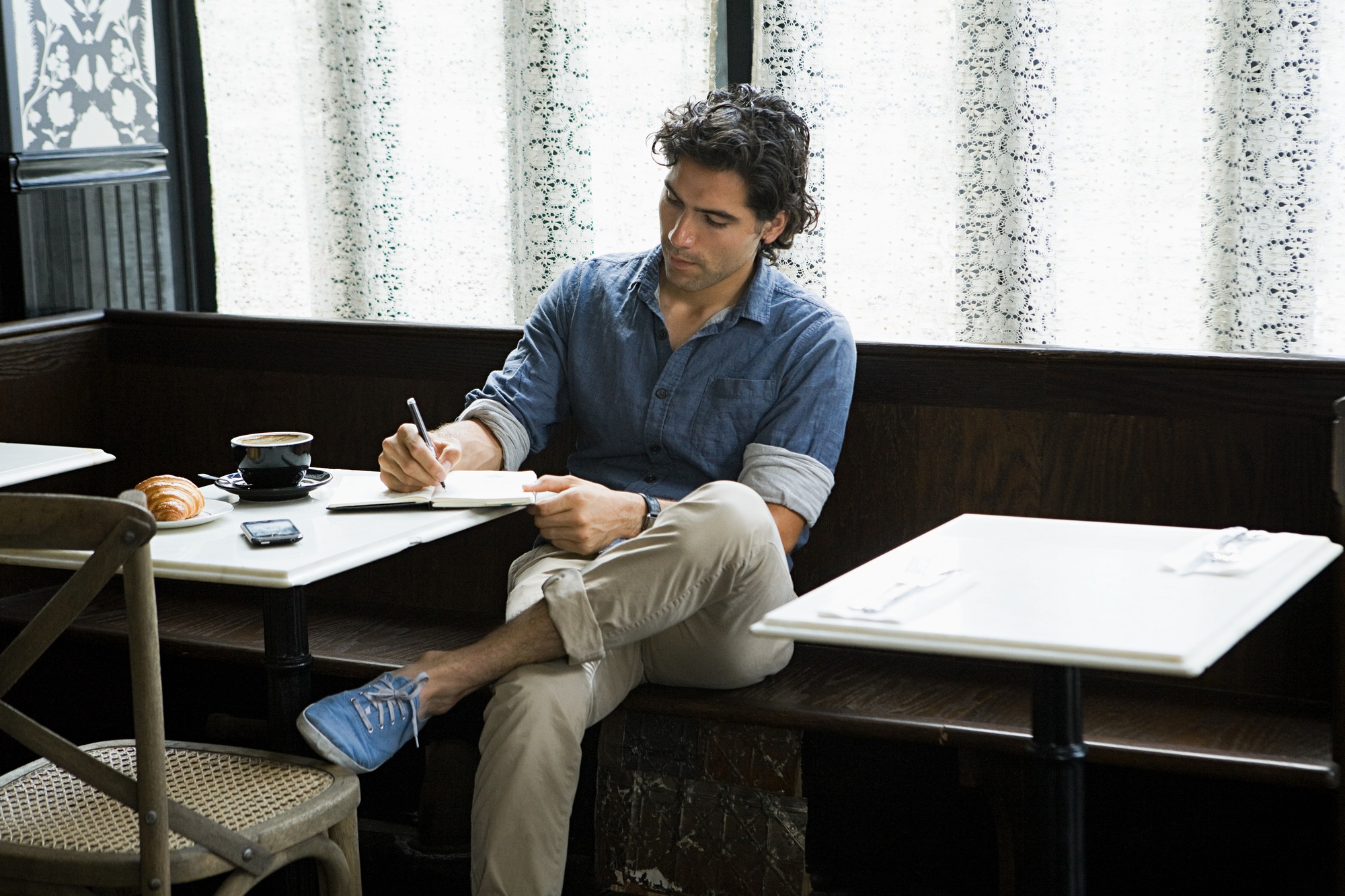 Man writing in coffee shop