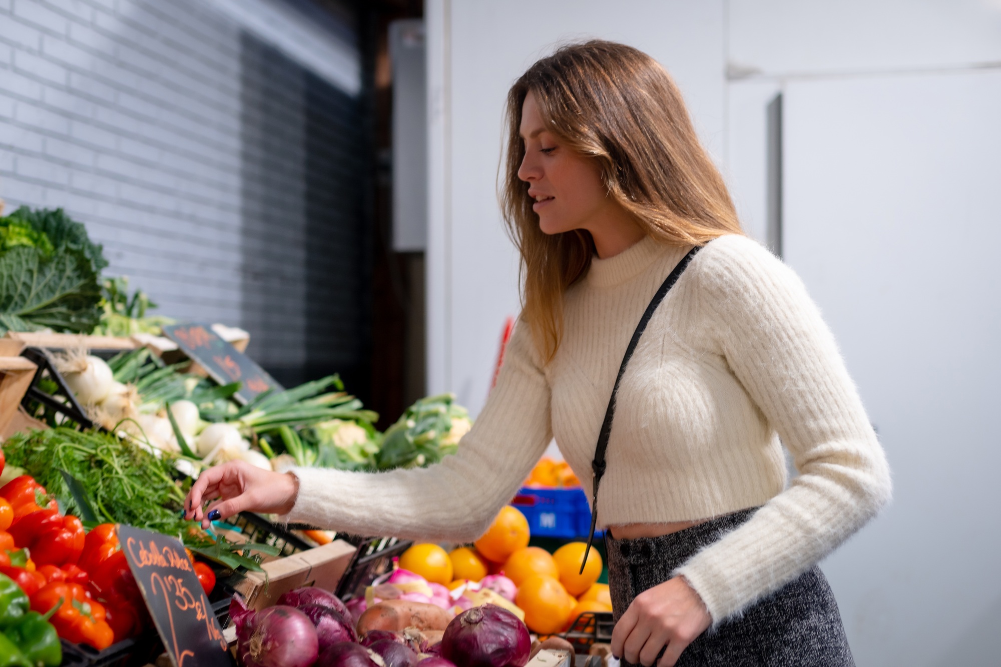 Woman buying vegetables and greens in grocery store